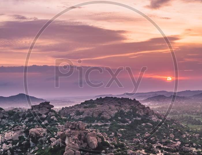 Landscape Of Rock Hills   in Hampi  With Sunset Sky in Background