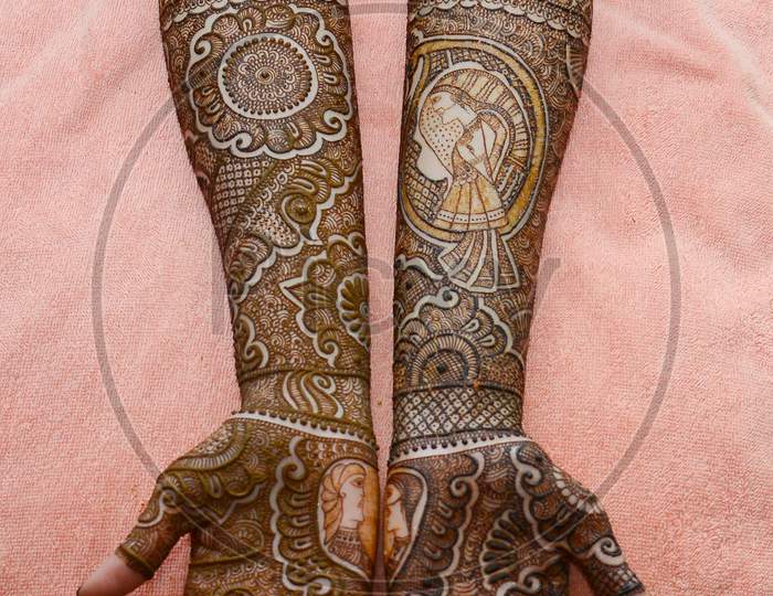 Indian Woman Putting On Mehandi Designs To Hands Closeup