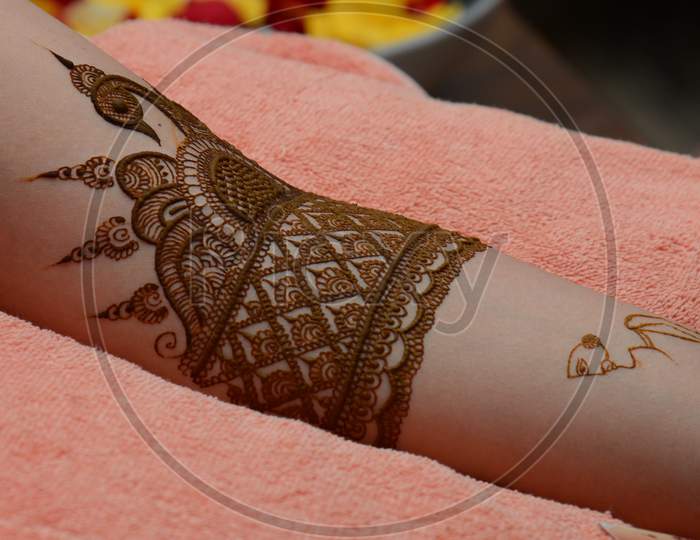 Indian Woman Putting On Mehandi Designs To Hands Closeup