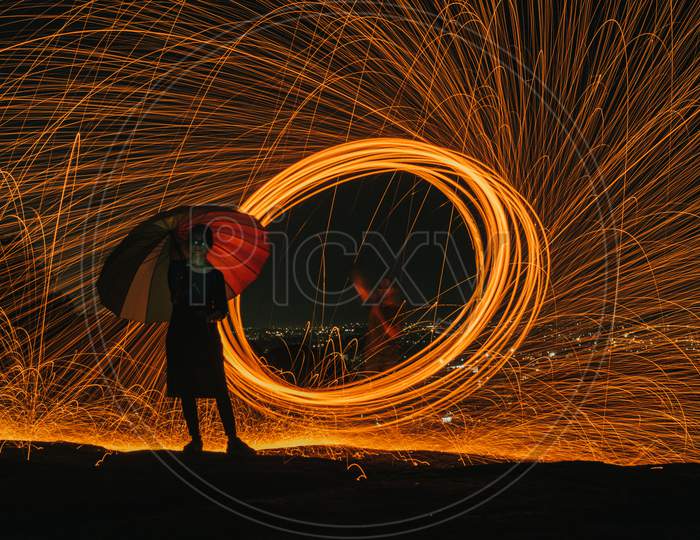 Steel Wool Photography With a Woman Holding Umbrella