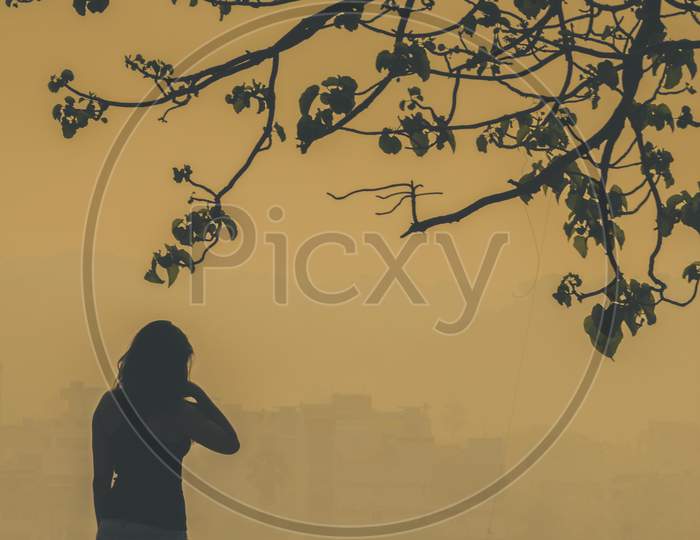 Silhouette of Young Woman Watching Sunrise in Hyderabad