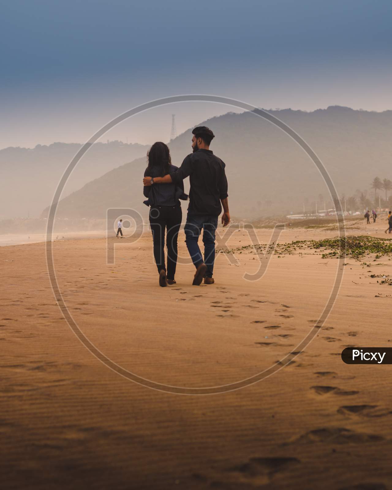 A Couple Walking In a Beach