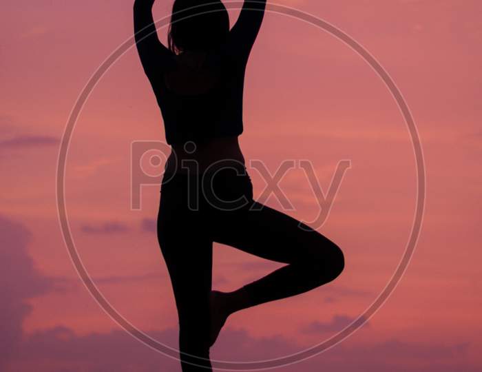 Silhouette Of Woman With Yoga Postures