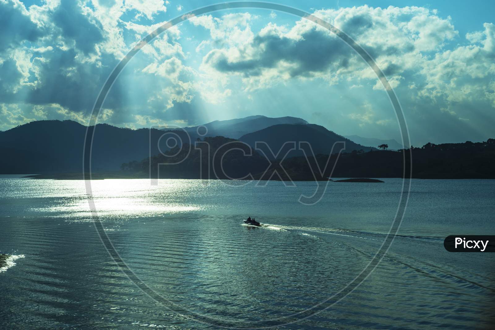 A Boat in Umiam Lake with Mountains in Background