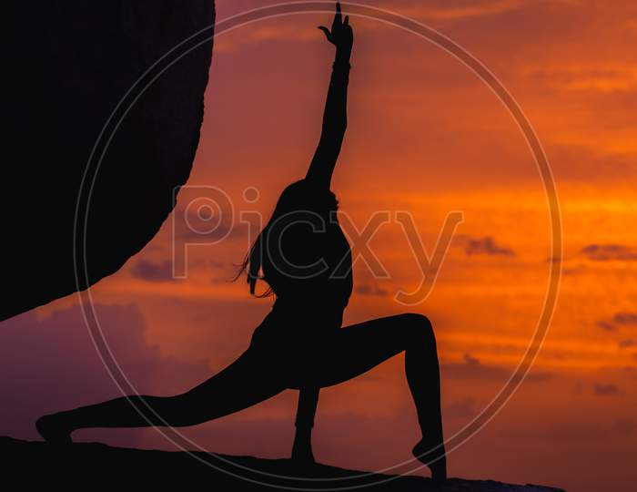 Silhouette Of Woman With Yoga Postures