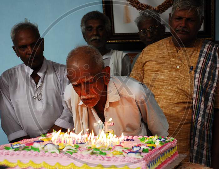 Old Man Cutting Cake In an Old Age Home