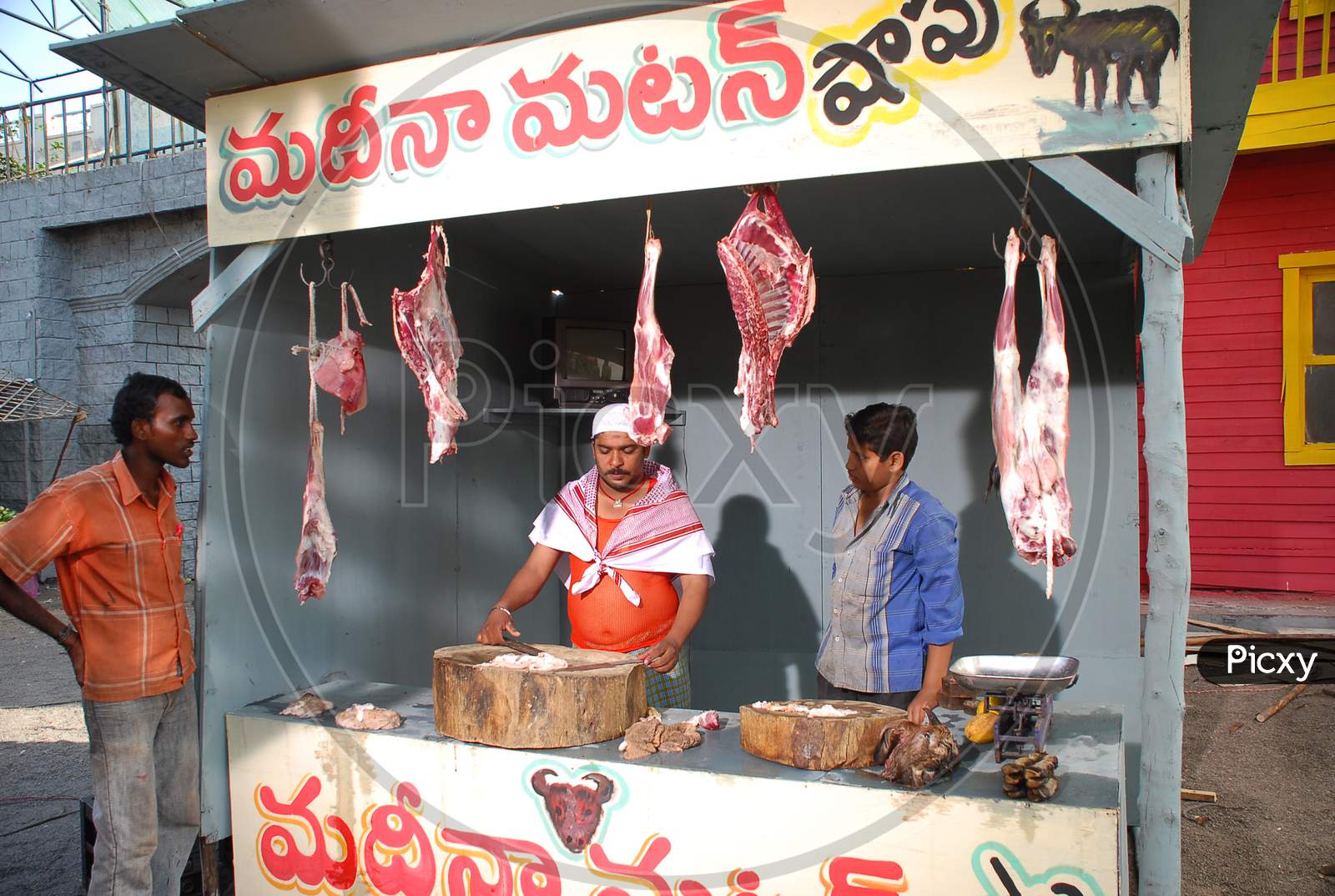 Butcher Shop With Meat And Butcher with Knife In Hand
