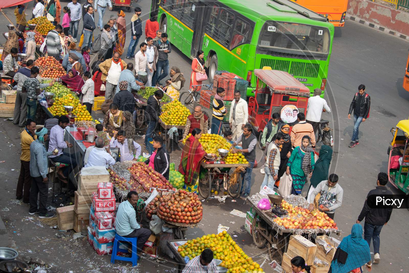 Fruit sellers selling fruits on their stalls or thelas
