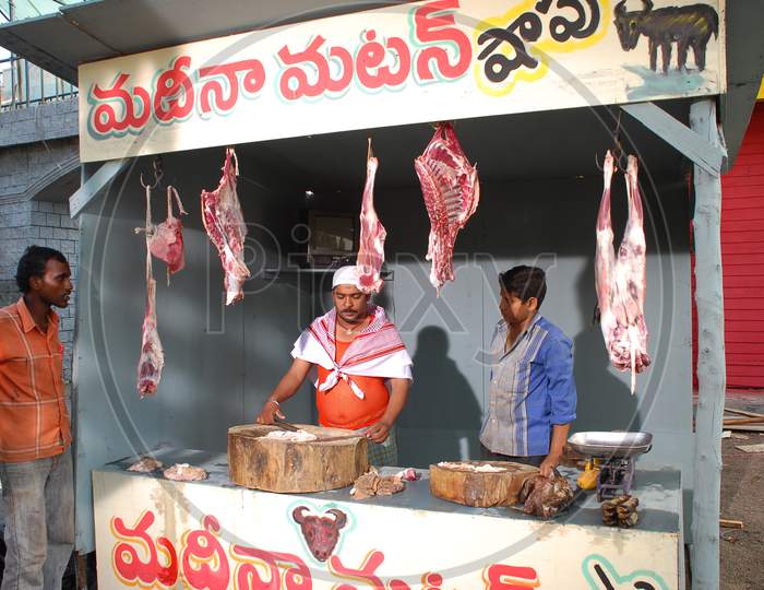 Butcher Shop With Meat And Butcher with Knife In Hand