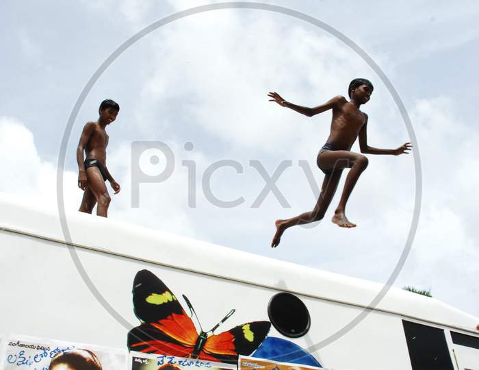 Children Diving To River From a Bus