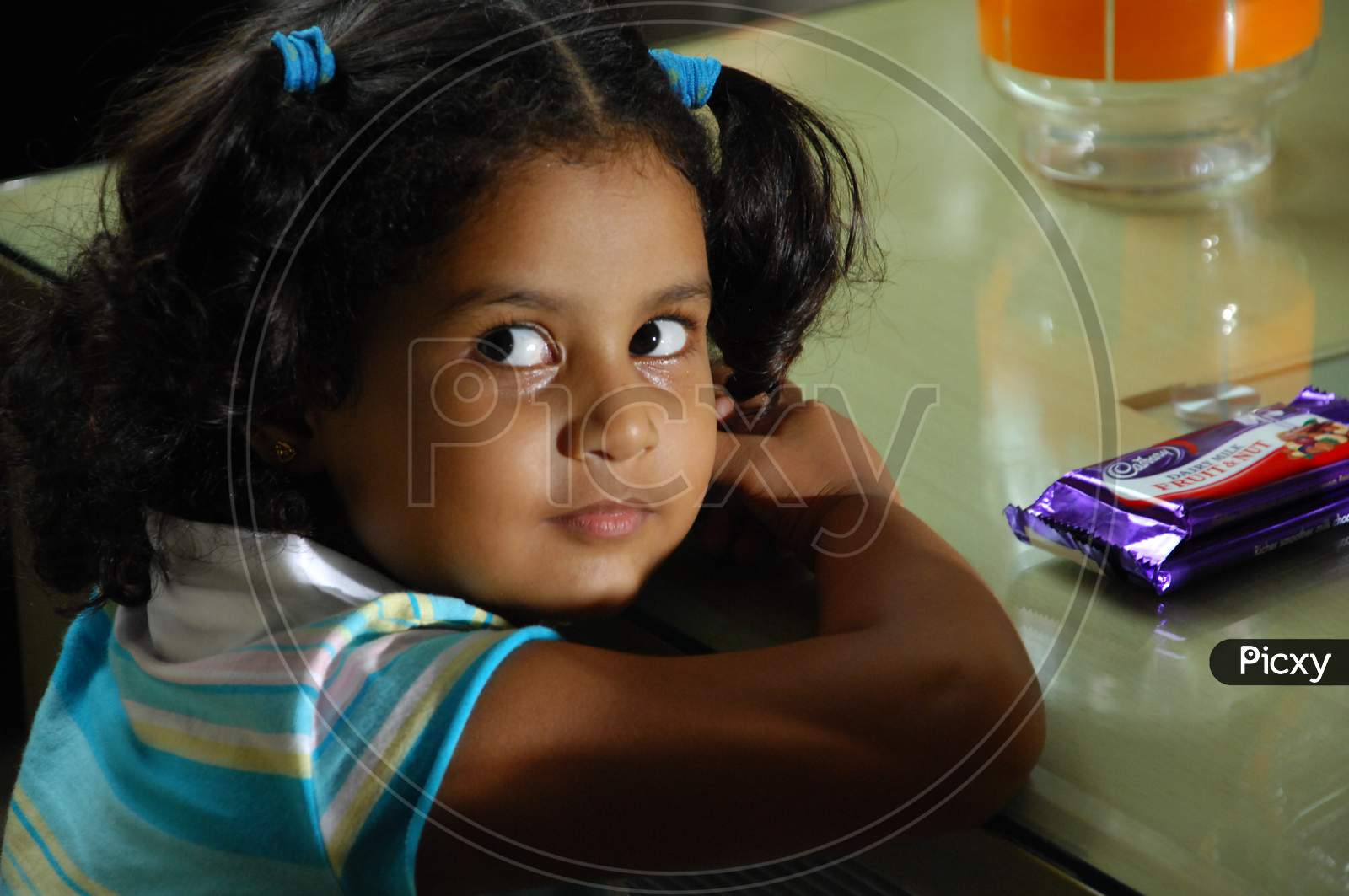 Young Girl Child At a Dining Table