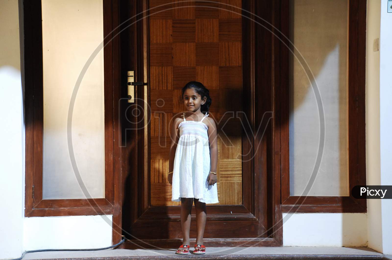 Young Girl At a Door Step Of a House