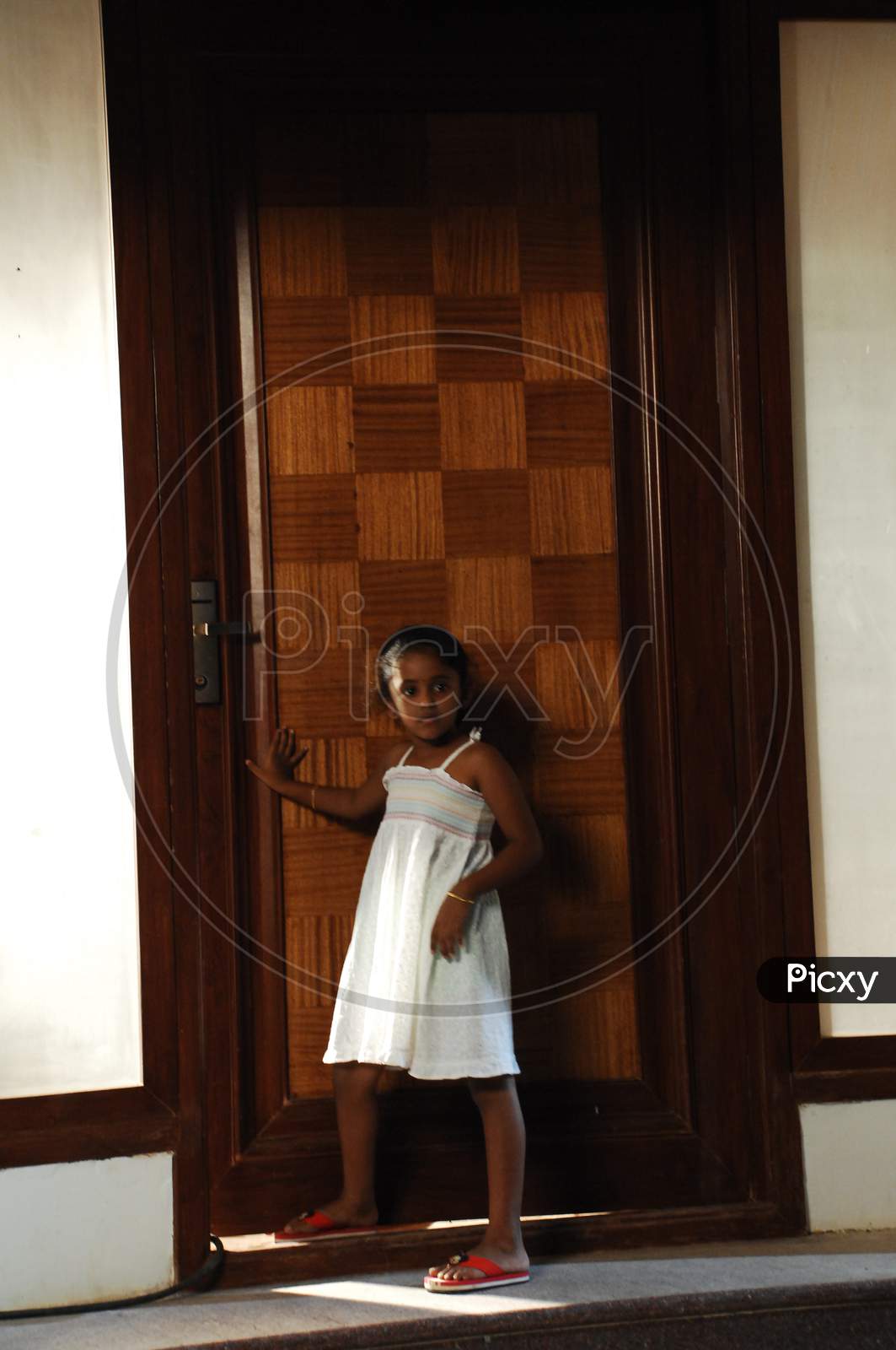Young Girl At a Door Step Of a House