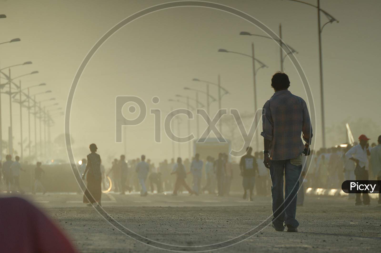 People Walking on Roads in Morning Haze