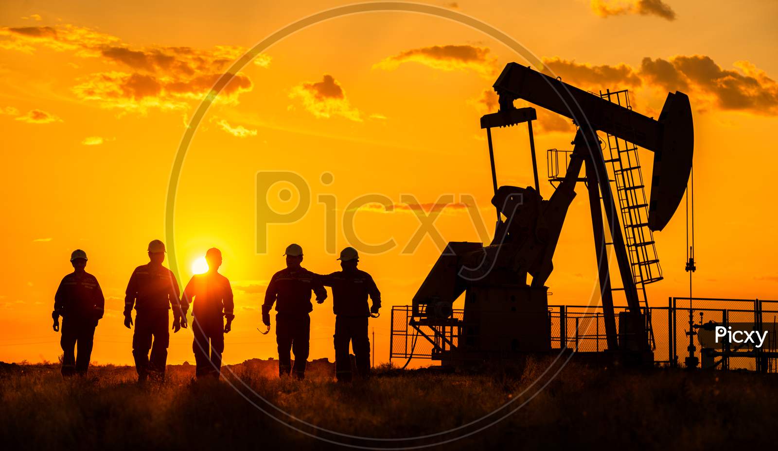 Silhouette Of Oil Rig Workers At a Off Shore Base