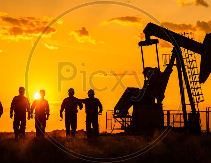 Silhouette Of Oil Rig Workers At a Off Shore Base