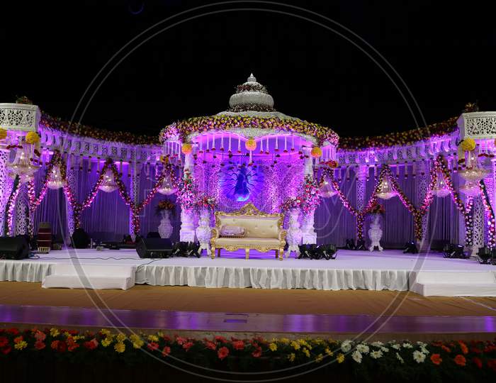 Wedding Reception Decorated Stages with Flowers And Neon Lights