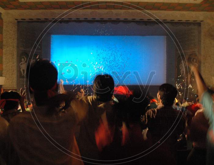 Long Exposure Of People In a Theater Enjoying The Movie Release Forming a Patterns Background