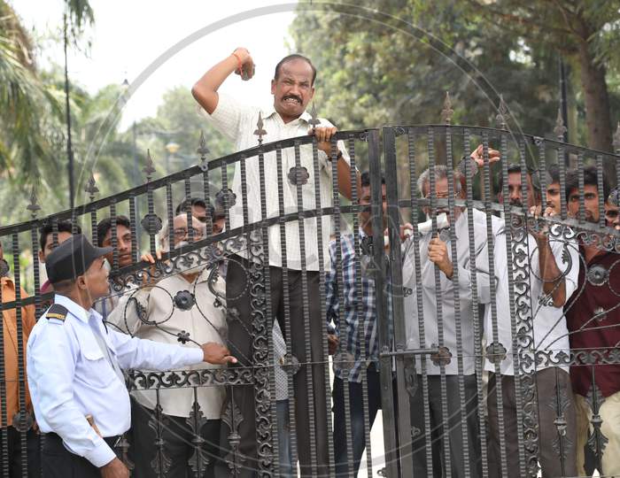 People Protesting At a House Gate With Slogans And Throwing Stones in Movie Working Stills