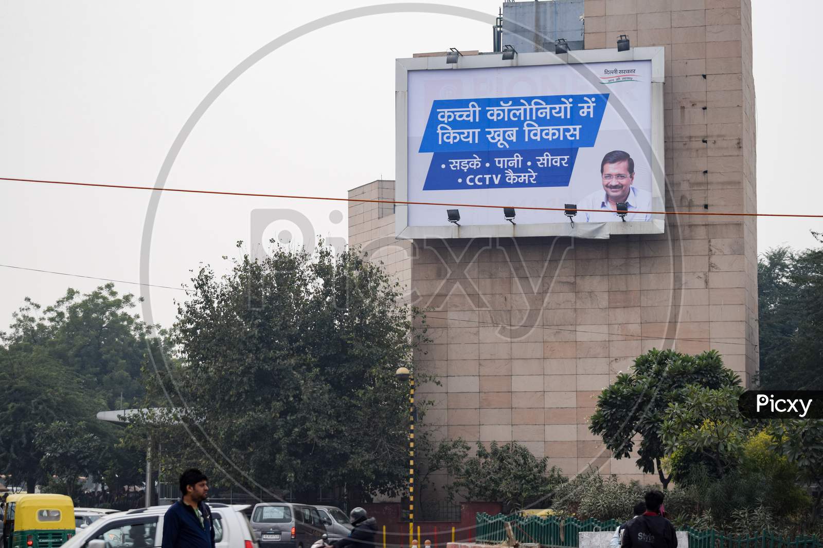 An advertisement about development in unauthorized colonies in delhi by Aam Aadmi Party AAP and photo of Arvind Kejriwal on it