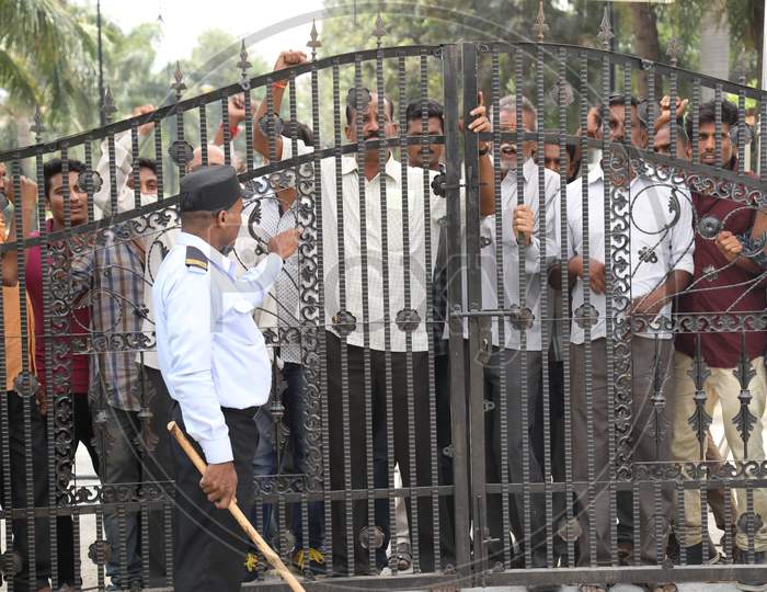People Protesting At a House Gate With Slogans And Throwing Stones in Movie Working Stills