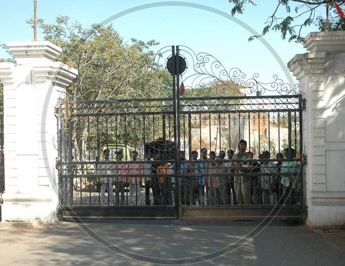 People Protesting At a House Gate With Slogans  in Movie Working Stills