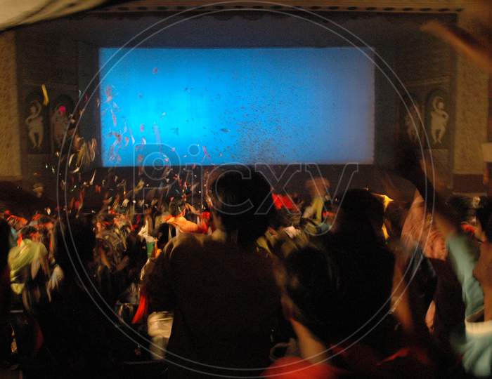 Long Exposure Of People In a Theater Enjoying The Movie Release Forming a Patterns Background