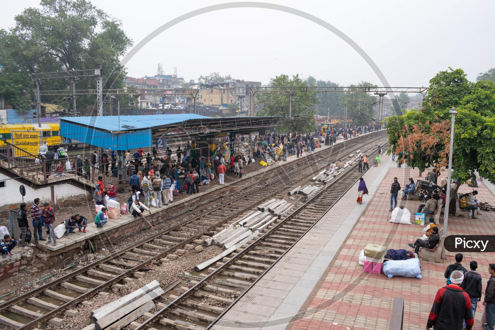 passengers waiting at the platforms and railway track at delhi sadar bazar railway station