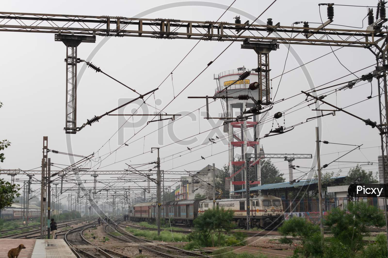 Railway pylons carrying overhead wires with high voltage at a railway track near Delhi Sadar Bazar railway station