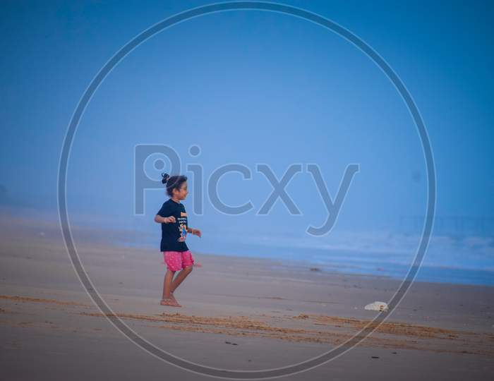 Little girl playing in the beach