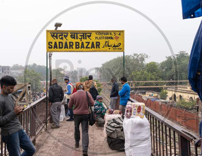 Passengers waiting at the entry gate of sadar bazar market railway station