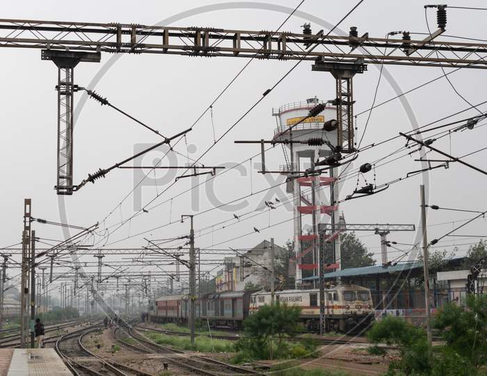 Railway pylons carrying overhead wires with high voltage at a railway track near Delhi Sadar Bazar railway station