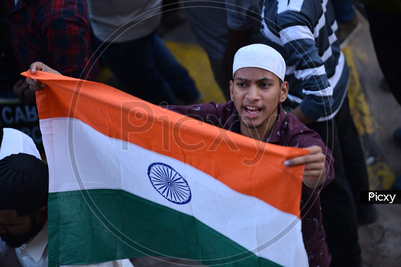 A protester holds Indian Flag while demonstrating against Citizenship Amendment Act 2019