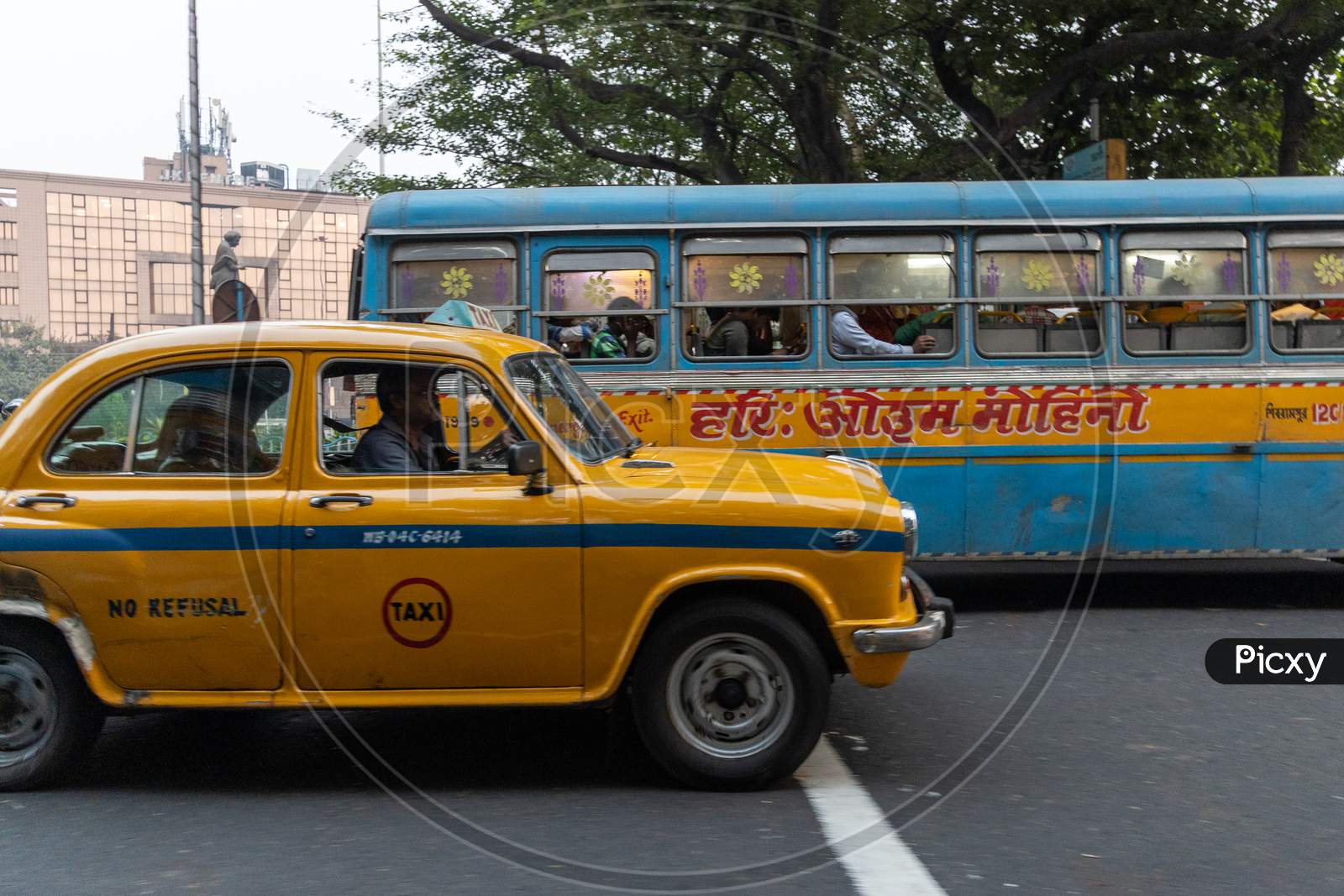 Yellow Cabs And WBTC City Buses In Kolkata Streets