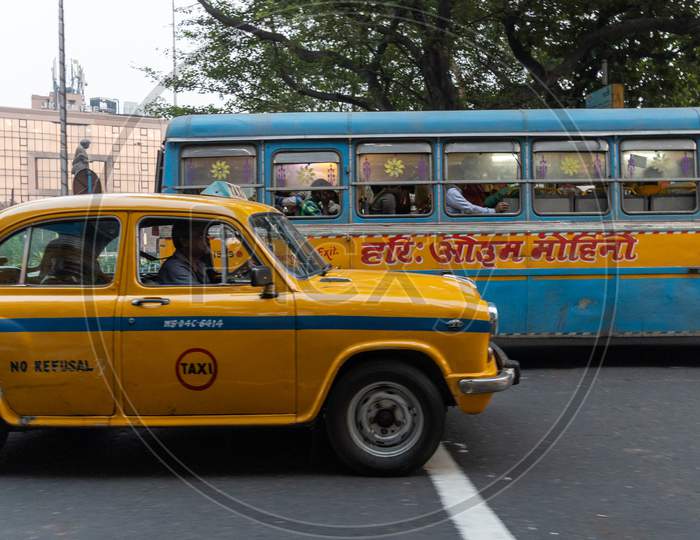 Yellow Cabs And WBTC City Buses In Kolkata Streets