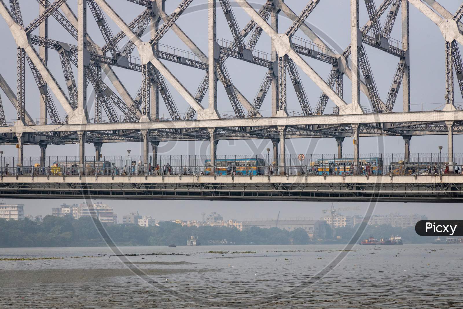 A View Of Howrah Bridge With Commuting Vehicles Over Hooghly River in Kolkata