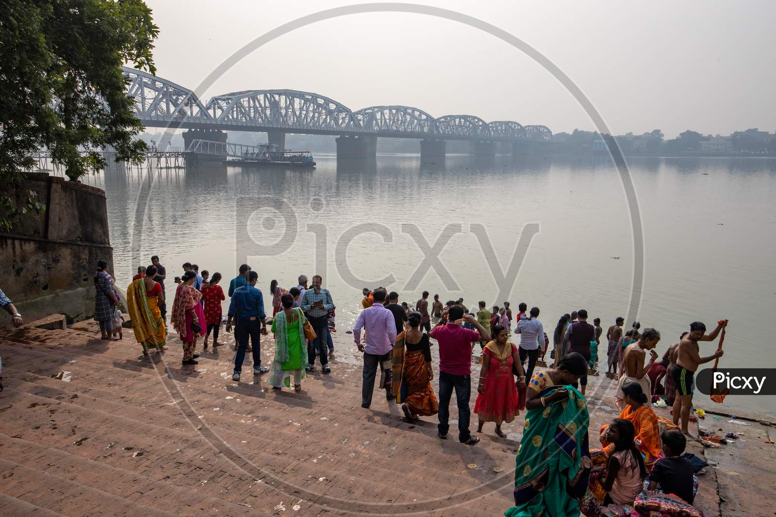 Devotees Taking Bath in Hooghly river Near Dakshineswar Temple In Kolkata