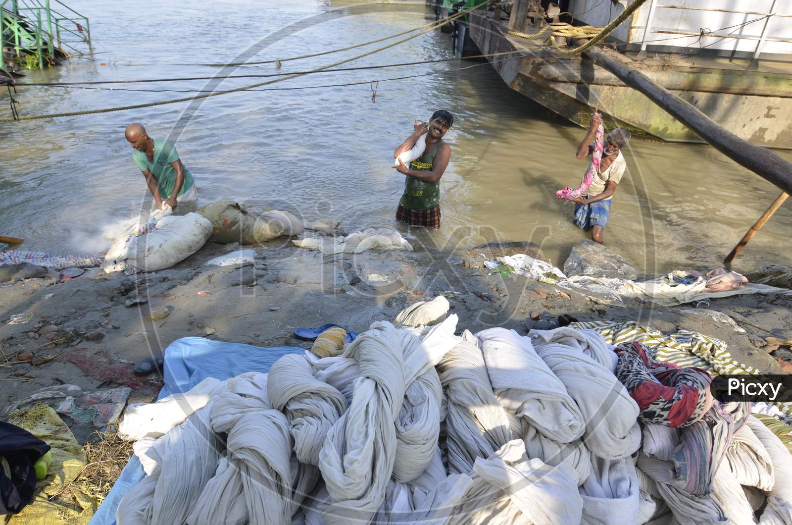 Indian Washerman or Dhobi Washing Clothes on A River Bank