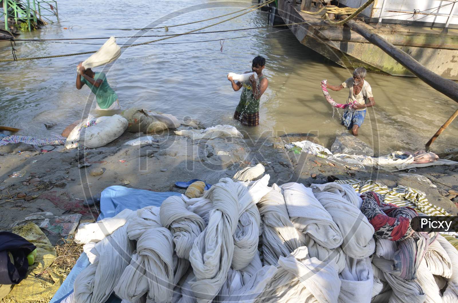 Indian Washerman or Dhobi Washing Clothes on A River Bank
