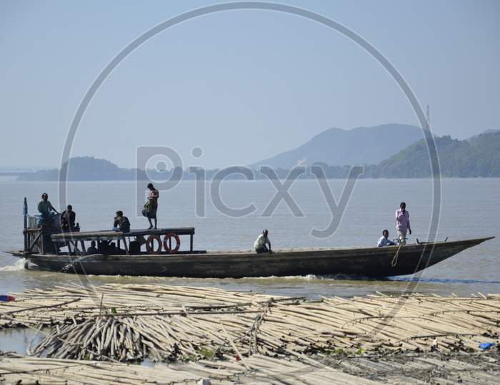 Commuting Old Wooden Boats on Bramhaputra River in Assam
