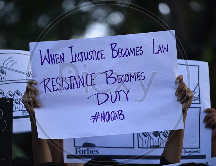 Student Holding a Placard Saying When Injustice becomes Law Resistance becomes Duty, Students Protesting against Citizenship Amendment Act 2019
