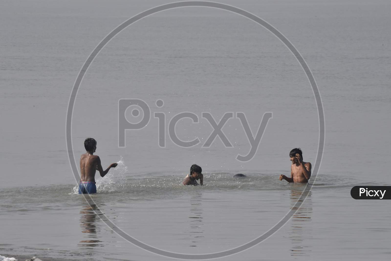 Young Indian Boys  Swimming In River Bramaputra In Assam
