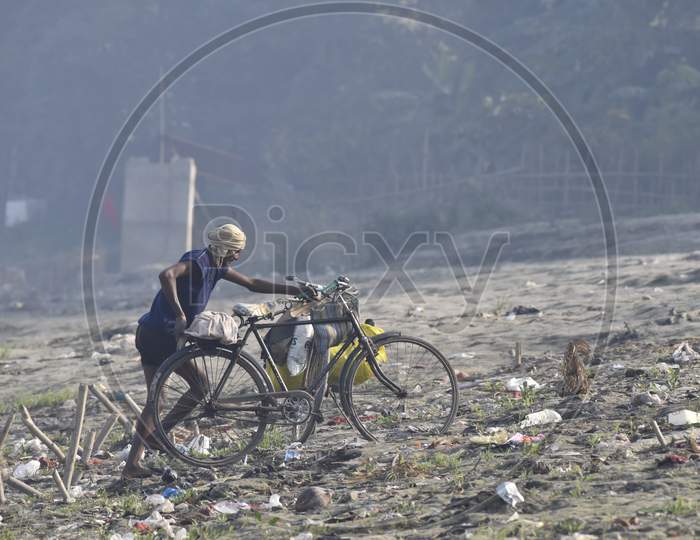 A Fisherman  With Bicycle on Bramhaputra River Bank