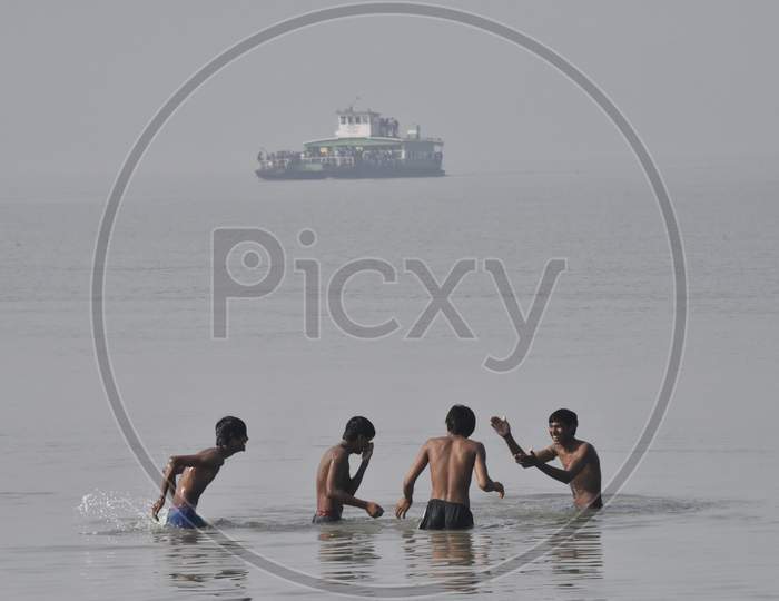 Young Indian Boys Playing And Swimming in River Bramaputra In Assam