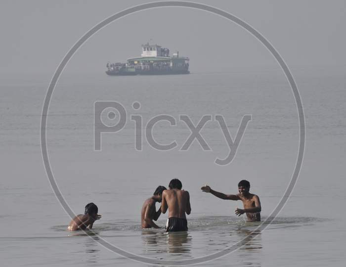 Young Indian Boys Playing And Swimming in River Bramaputra In Assam
