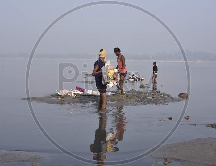 Indian Washer Man Or Dhobi  Washing Clothes in River Bramhaputra In Assam