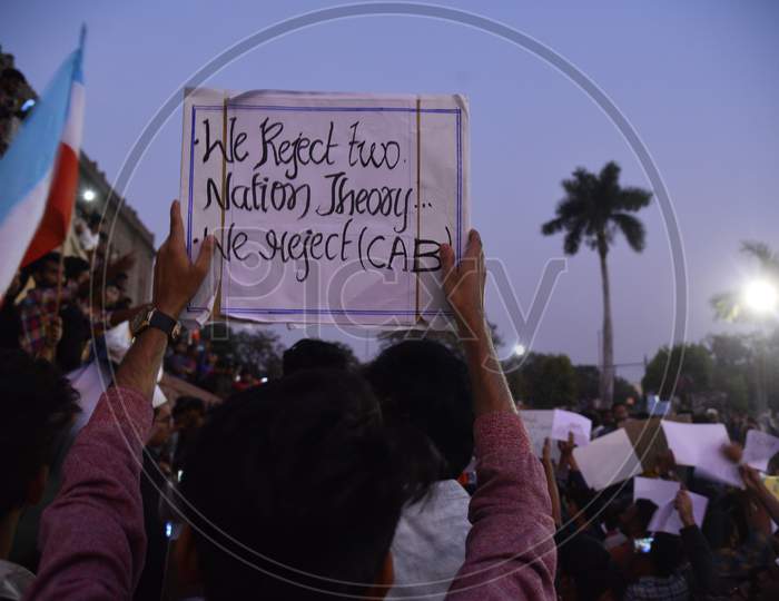 protesters hold placards with slogans 'we reject two nation theory'