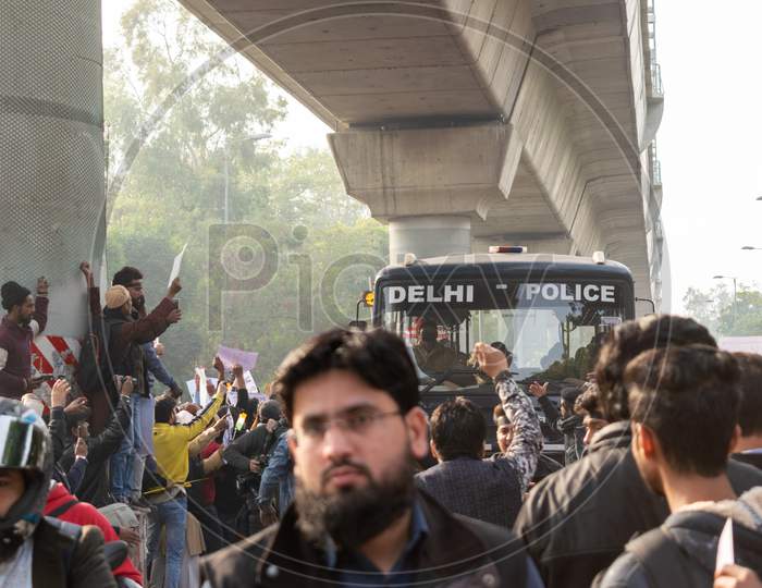 Delhi Police bus passing through the crowd during The Protest Against Caa And Nrc Outside Jamia Millia Islamia University