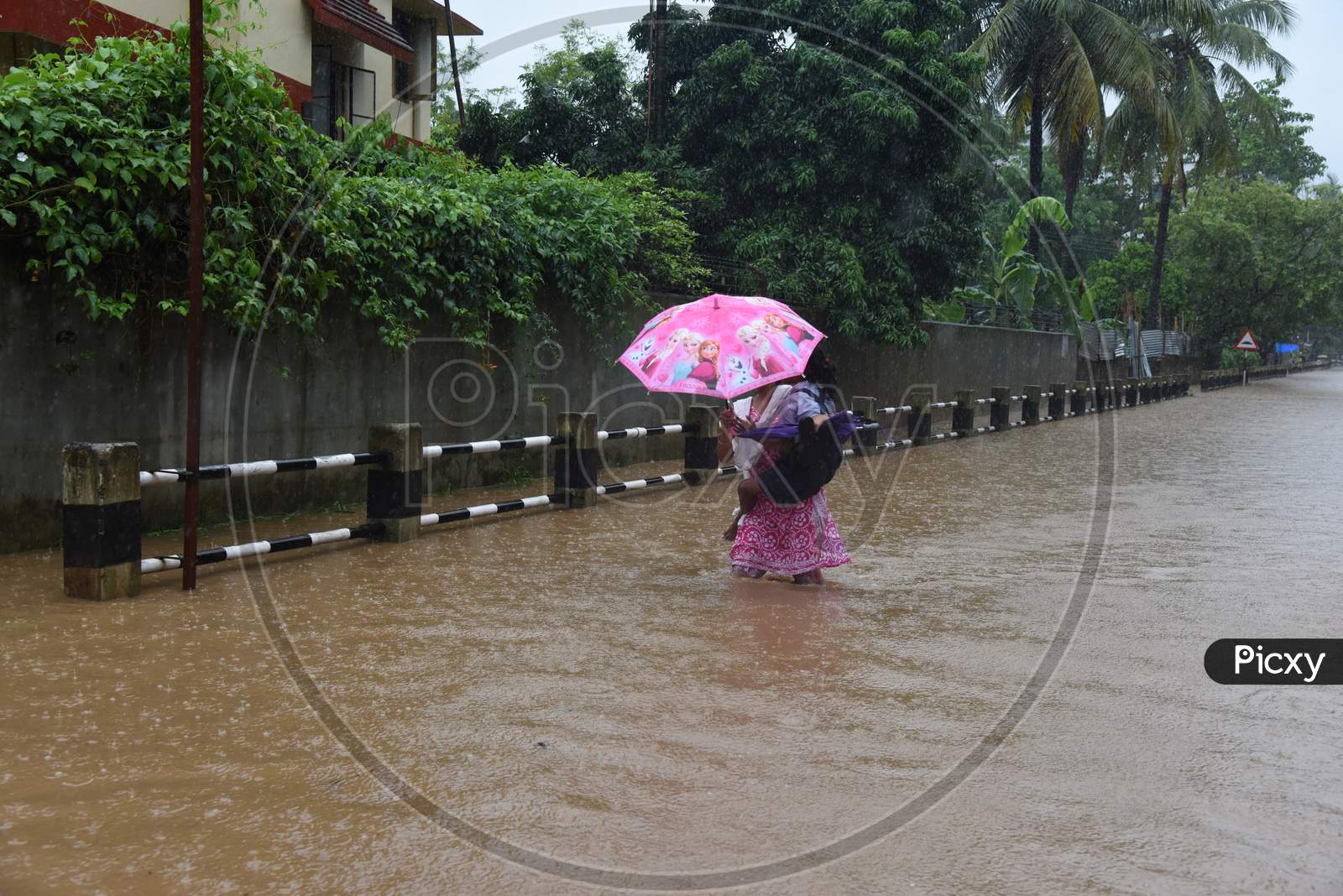 Pedestrians Taking Cover From Heavy Rain  Due To Seasonal Floods In Guwahati City, Assam On June 13 2017