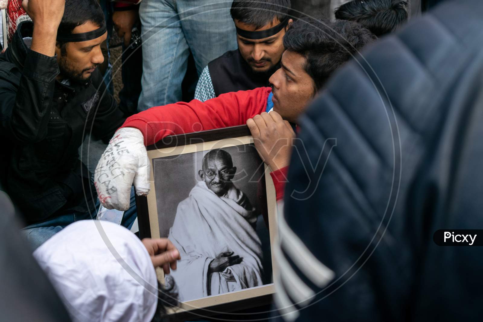 Students holding a picture of Mahatma Gandhi during protest against CAA and NRC outside Jamia Millia Islamia, A Central University in New Delhi